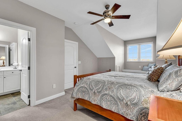 bedroom with connected bathroom, baseboards, ceiling fan, light colored carpet, and lofted ceiling