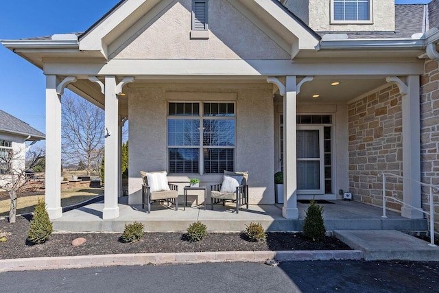 entrance to property with stucco siding, stone siding, and covered porch