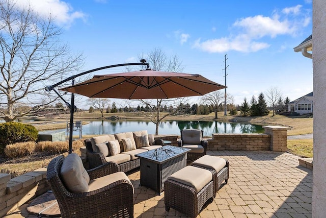 view of patio / terrace with a water view and an outdoor living space with a fire pit