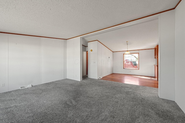 spare room with visible vents, a textured ceiling, crown molding, and carpet