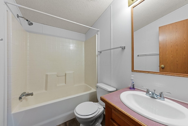 bathroom with washtub / shower combination, a textured ceiling, vanity, and toilet