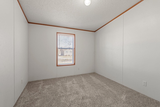 unfurnished room featuring carpet flooring, a textured ceiling, and ornamental molding