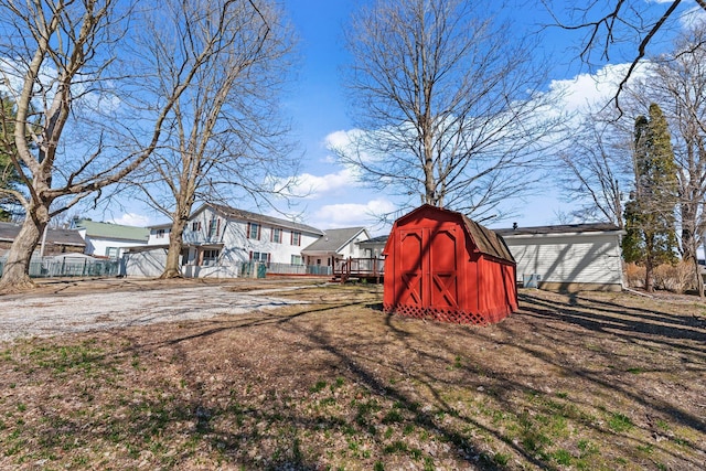 view of yard with a storage shed, an outdoor structure, and fence