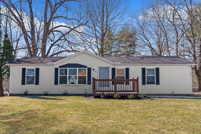 ranch-style house featuring a front yard and a deck