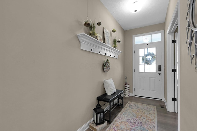 interior space featuring wood finished floors, visible vents, and baseboards