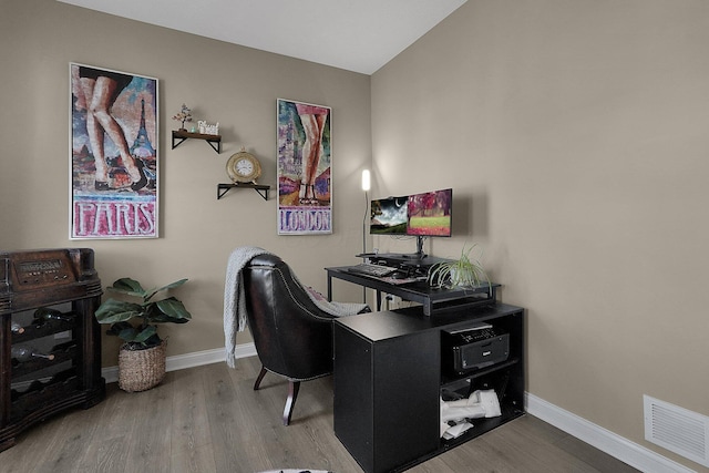 home office with visible vents, baseboards, and wood finished floors