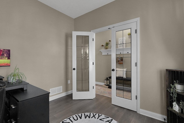 interior space featuring visible vents, french doors, baseboards, and dark wood-style flooring