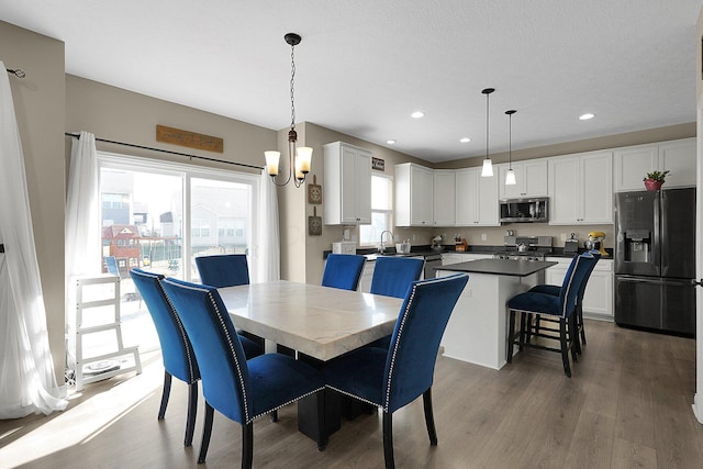 dining room featuring recessed lighting and wood finished floors