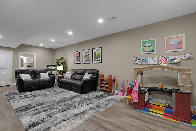 living area featuring visible vents, recessed lighting, and wood finished floors