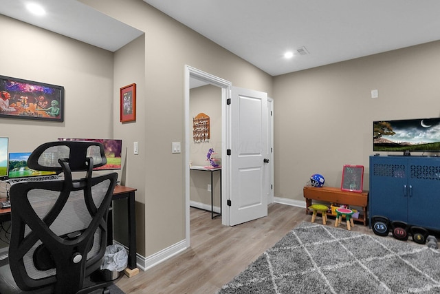 rec room with light wood-style flooring and baseboards