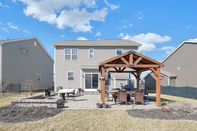 rear view of house featuring a gazebo, a lawn, a patio, and fence