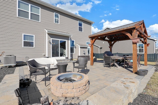 view of patio with a gazebo, central AC unit, a fire pit, and fence