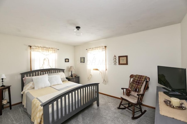 carpeted bedroom with baseboards and multiple windows