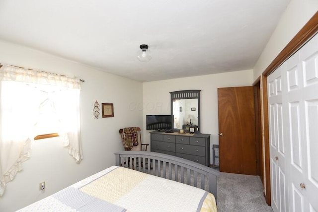 carpeted bedroom with a closet