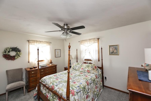 carpeted bedroom with baseboards, multiple windows, and a ceiling fan