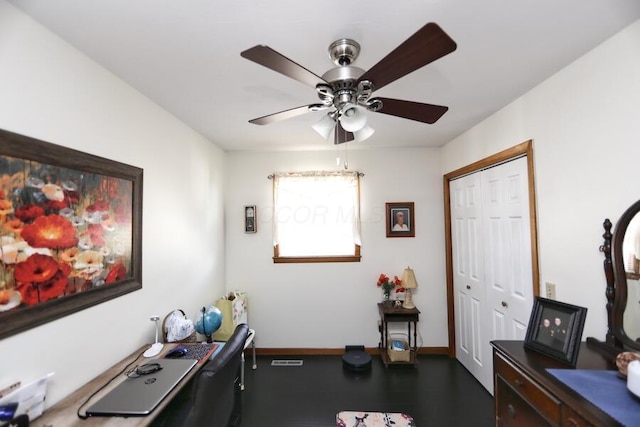 office featuring a ceiling fan, baseboards, and dark wood-style flooring