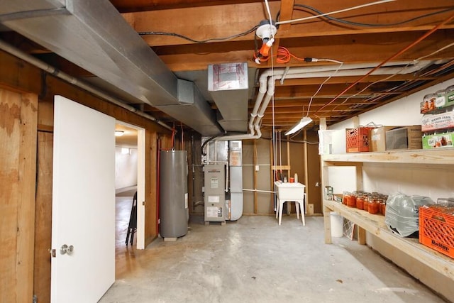 unfinished basement with a sink, heating unit, and electric water heater