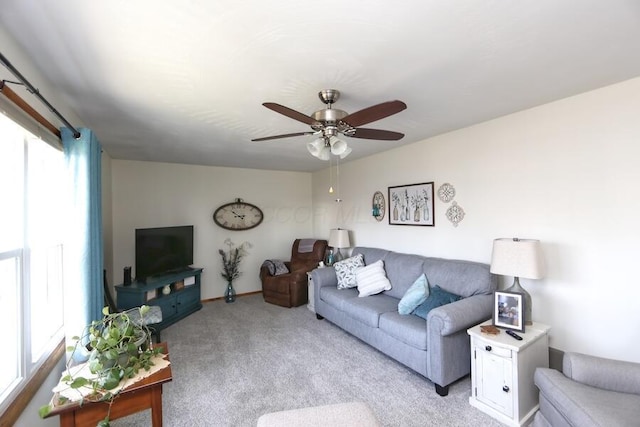 carpeted living room featuring a ceiling fan