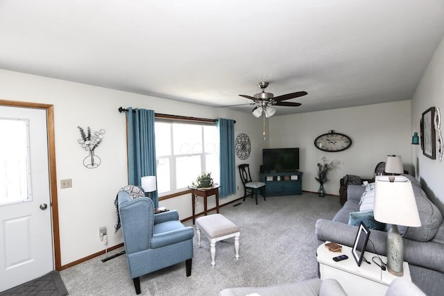 carpeted living area with visible vents, baseboards, and a ceiling fan