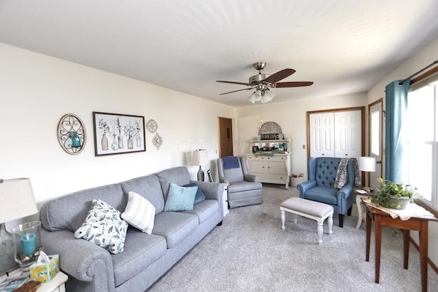 living room with plenty of natural light, carpet flooring, and a ceiling fan