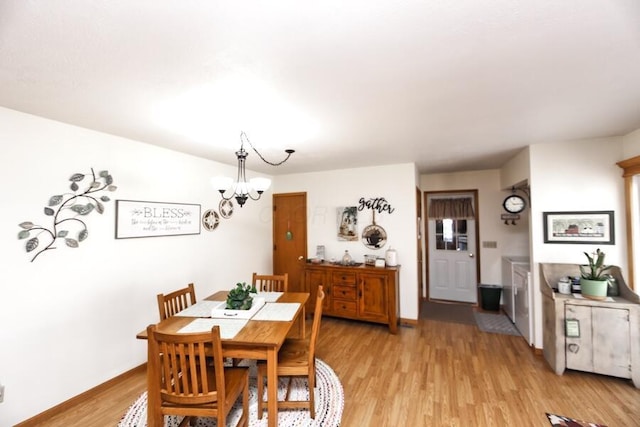 dining area with a notable chandelier, light wood-type flooring, and baseboards