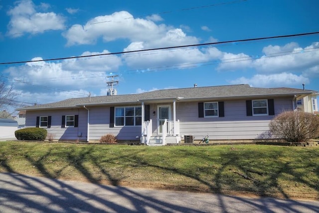 ranch-style home with a front yard and central AC