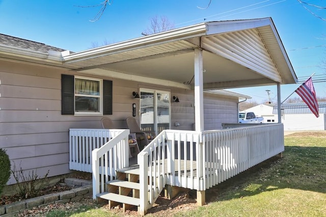 entrance to property with an attached carport and driveway