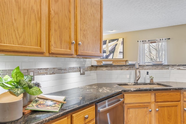 kitchen with a sink, dark stone countertops, a textured ceiling, decorative backsplash, and dishwasher