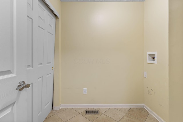 laundry room featuring light tile patterned floors, visible vents, hookup for a washing machine, and laundry area