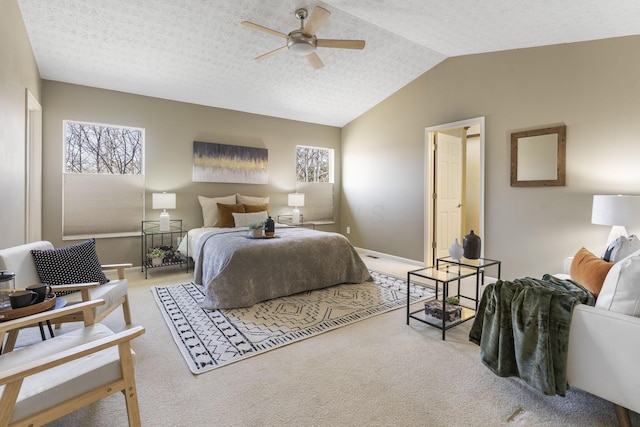 bedroom with a textured ceiling, multiple windows, carpet, and vaulted ceiling