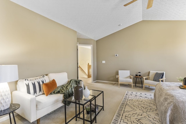 carpeted living room with baseboards, a textured ceiling, a ceiling fan, and vaulted ceiling