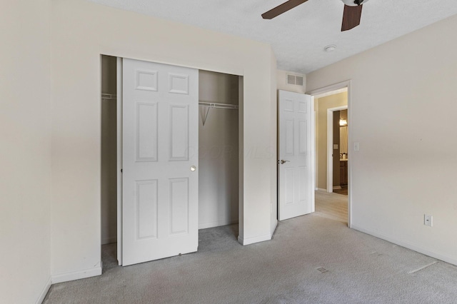 unfurnished bedroom with carpet, visible vents, a closet, and baseboards