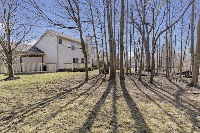 view of yard with a wooden deck and an attached garage