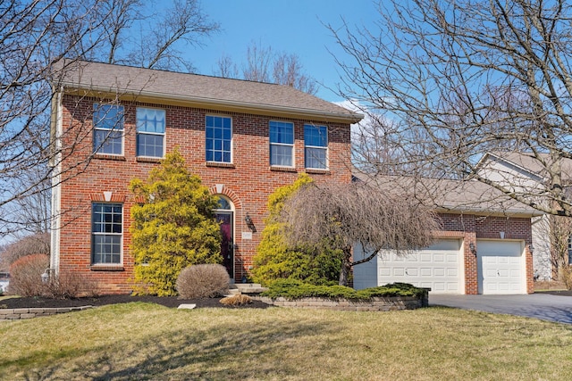 colonial-style house with a front yard, brick siding, an attached garage, and driveway