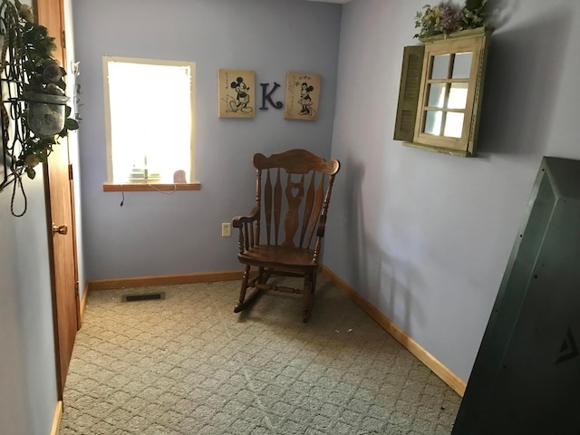 sitting room with visible vents, carpet, and baseboards