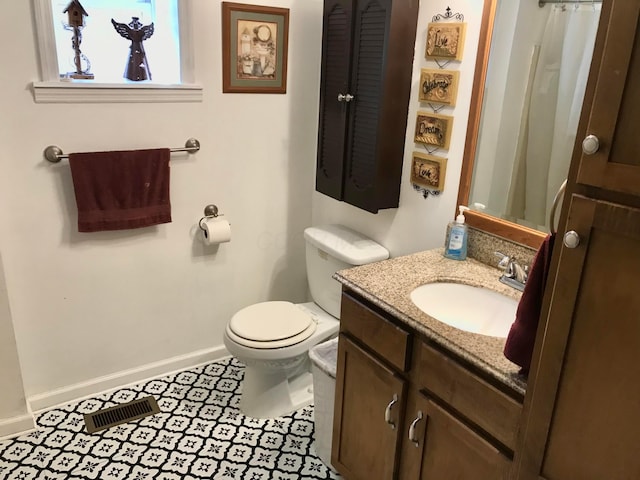 full bathroom featuring tile patterned flooring, visible vents, baseboards, toilet, and vanity