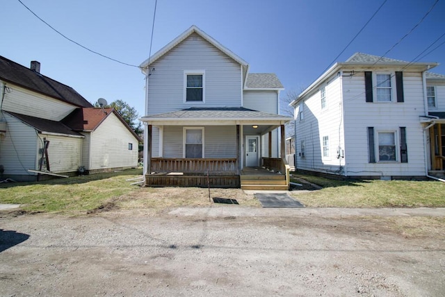 view of front of home featuring covered porch and a shingled roof