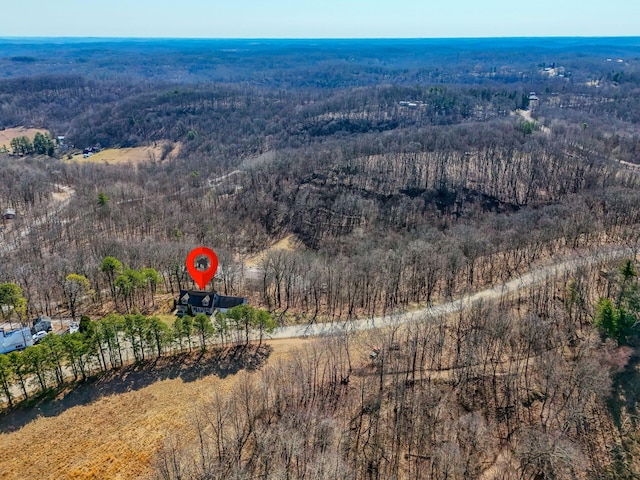 birds eye view of property featuring a wooded view