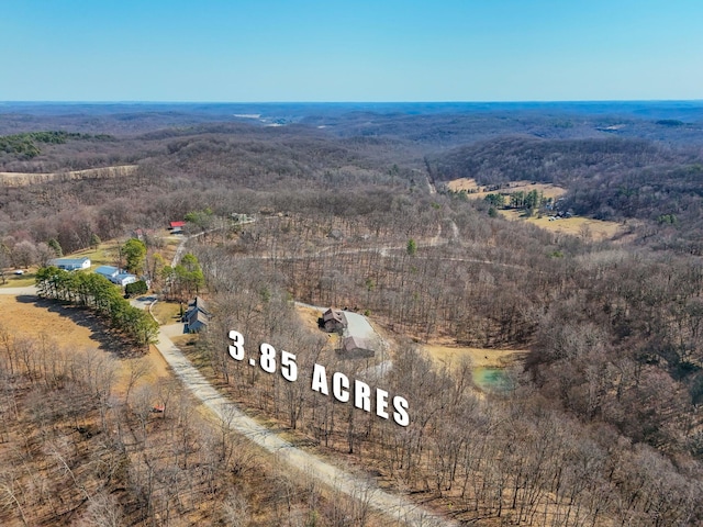 birds eye view of property with a wooded view