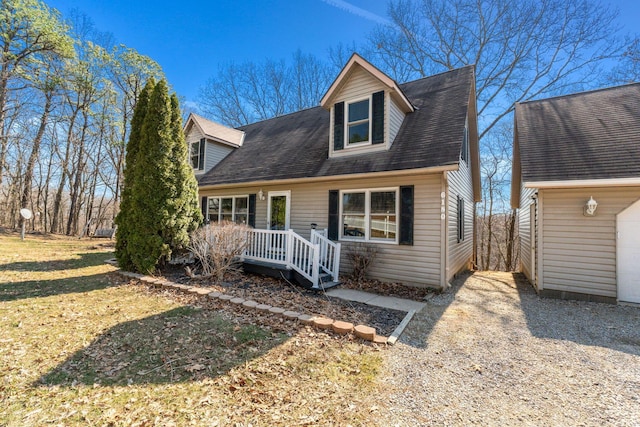 cape cod home with roof with shingles