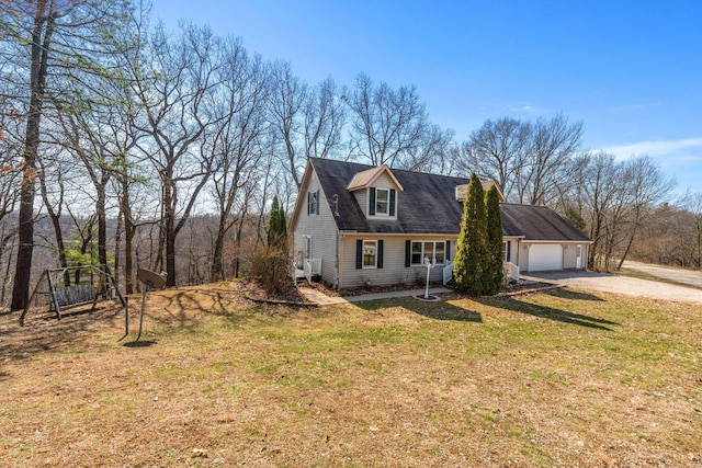 cape cod home with a garage, driveway, and a front lawn