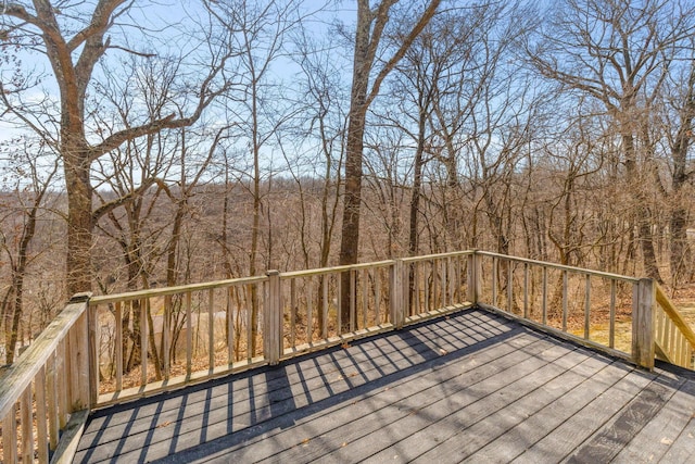 wooden terrace featuring a forest view