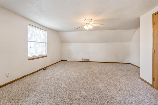 bonus room with visible vents, baseboards, and a ceiling fan