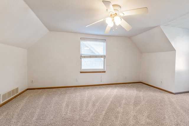 bonus room with visible vents, baseboards, vaulted ceiling, carpet floors, and a ceiling fan