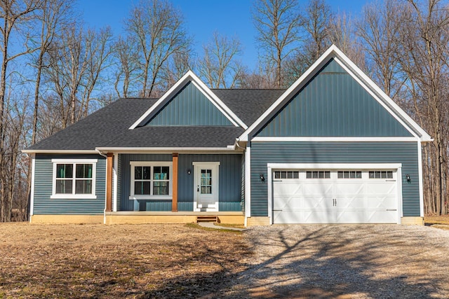 view of front facade featuring board and batten siding, gravel driveway, a porch, roof with shingles, and an attached garage