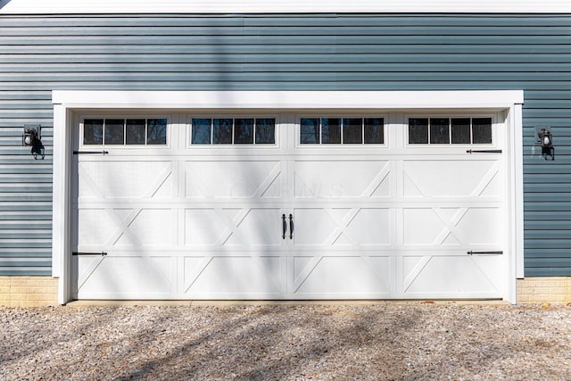 garage with dirt driveway