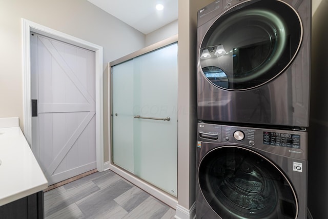 washroom featuring stacked washer / drying machine