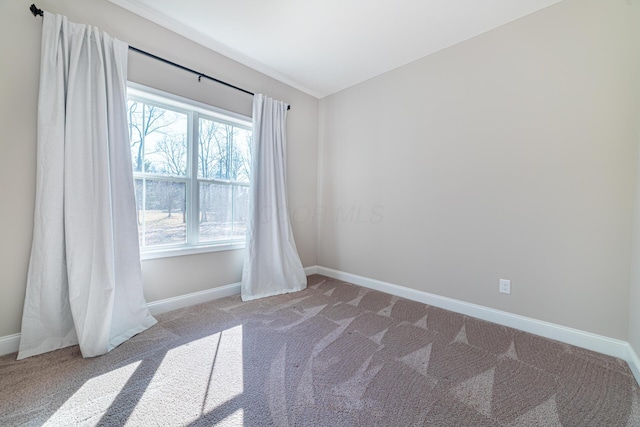 unfurnished room featuring baseboards and carpet