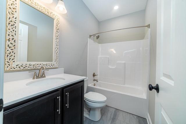 bathroom with shower / washtub combination, toilet, and vanity