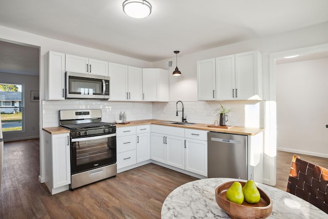 kitchen featuring wood counters, dark wood-style floors, a sink, and stainless steel appliances